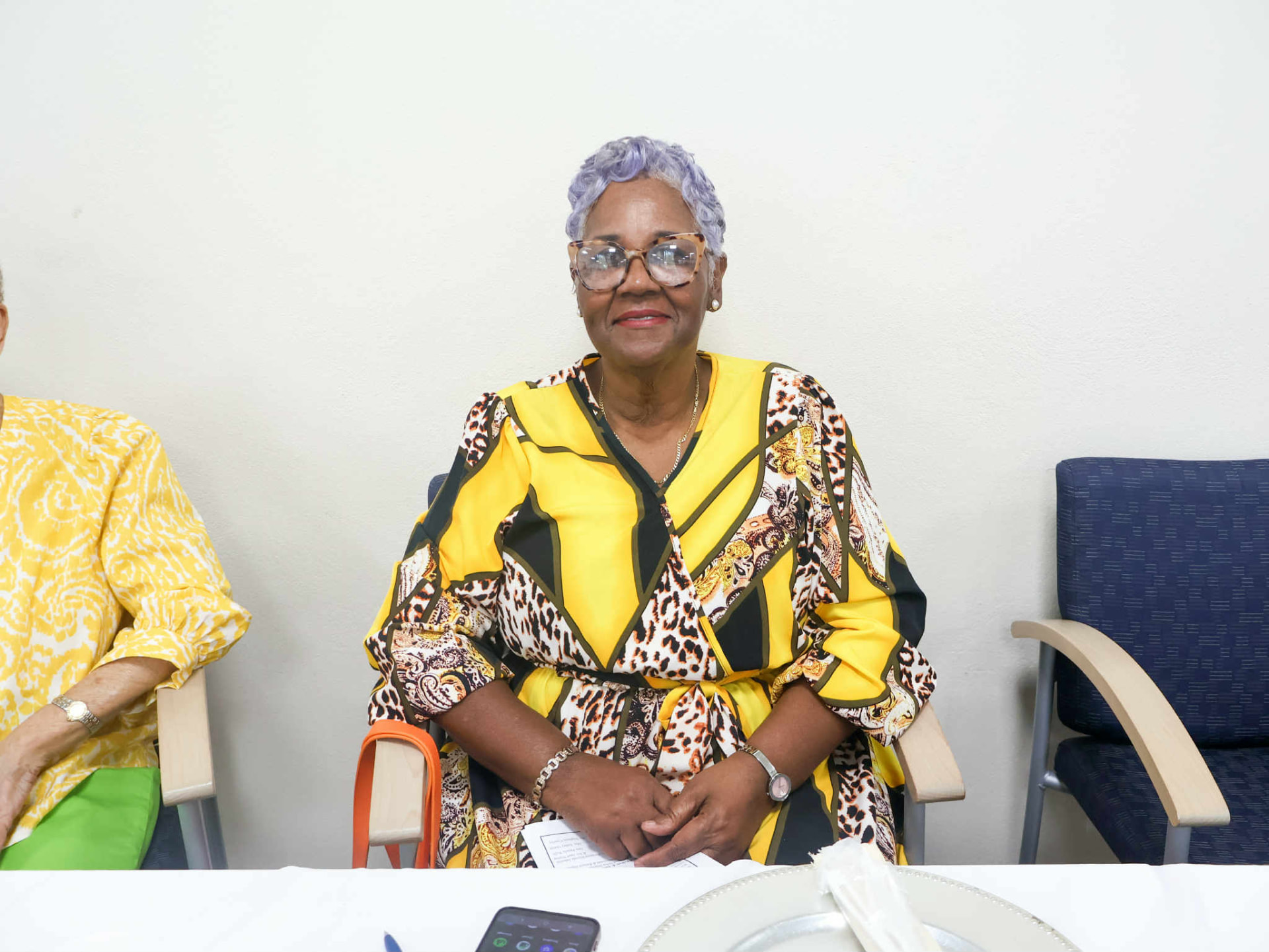 Guest smiling at her seat during the church community breakfast