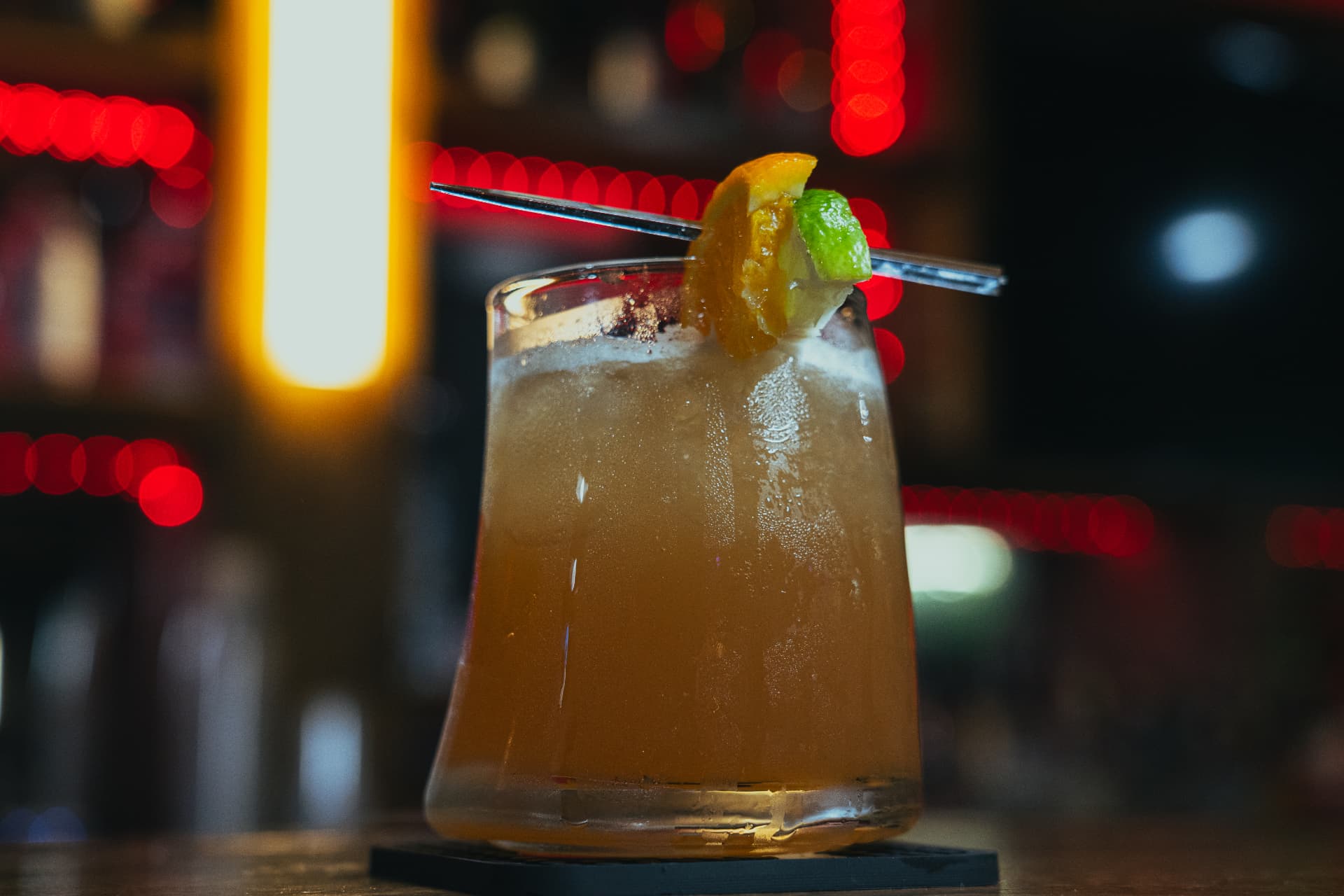 Cocktail on the bar at Joey's Restaurant with neon lights behind